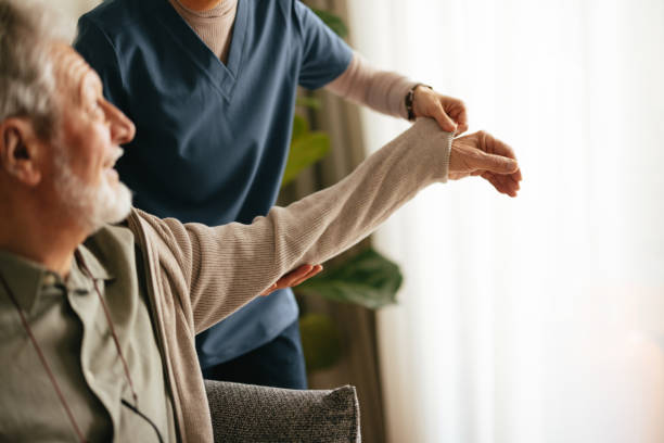 istock Anonymous Woman Helping Elderly Man Take off His Jacket in a Nursing Home 2087259330