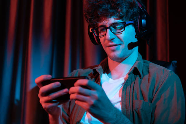 istock Smiling streamer team playing with Esport online on smartphone. Gusher. 2087281062