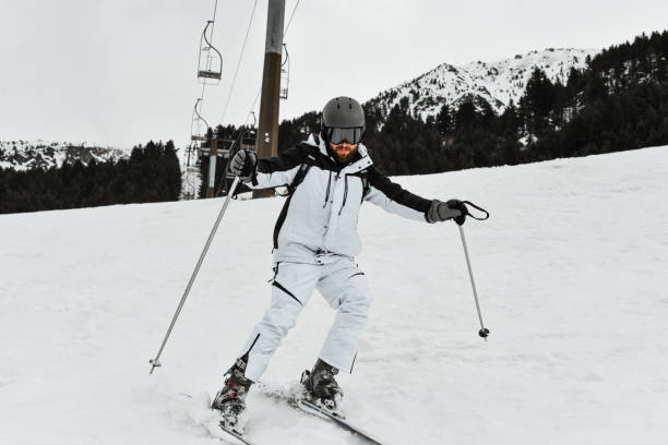 Modern Male Enjoying Skiing On Snowy Mountain Slopes