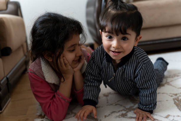 Brother and sister having fun at home.