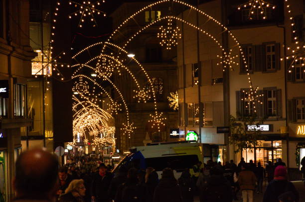 People walking on a street with Christmas lights in Basel, Switzerland - December 2, 2022