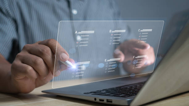 istock Concept filling out digital form checklist, take an assessment, questionnaire, evaluation, online survey, exam. Businessman Hand using stylus pen performance checklis laptop online checklist survey. 2087342347