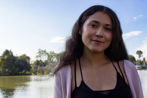 istock Beautiful young woman posing in a public park 2087395978