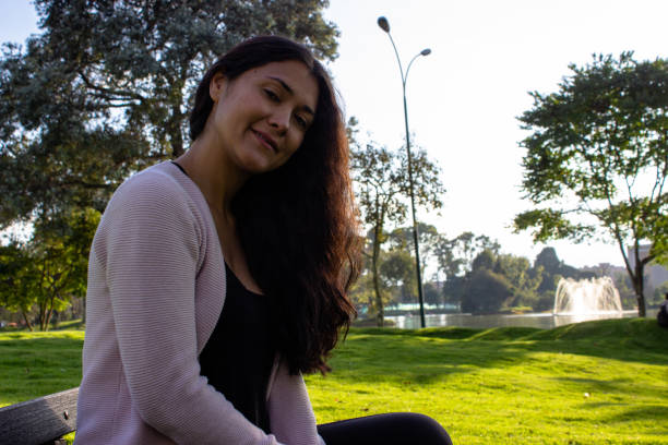 istock Beautiful young woman posing in a public park 2087398420
