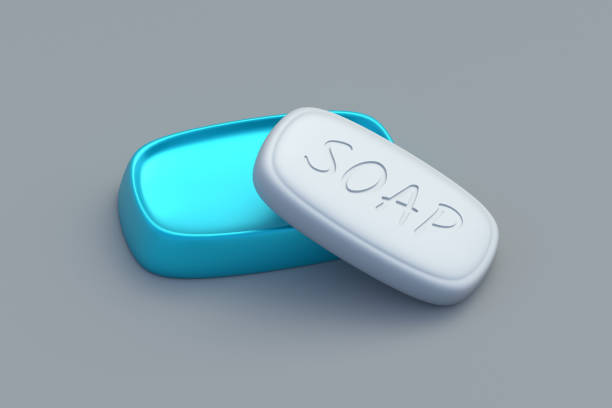 Soap bar near box on gray background. Laundry accessories. Handmade antibacterial agent. Cleaning and hygiene. 3d render
