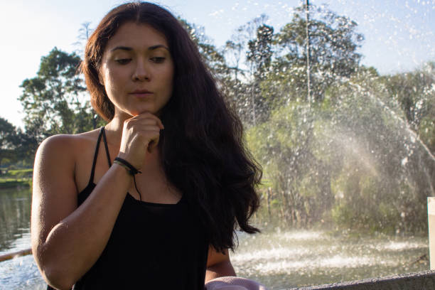 Beautiful young woman posing in a public park
