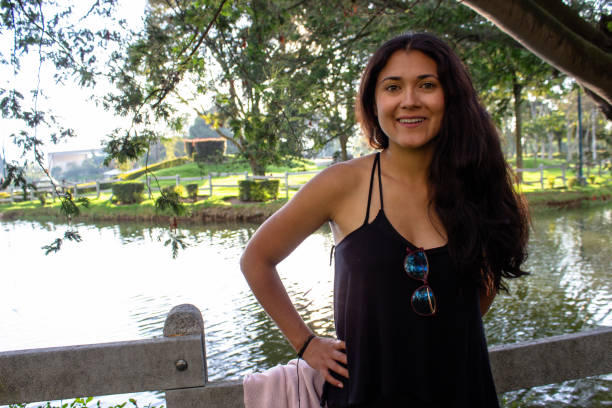 istock Beautiful young woman posing in a public park 2087408345
