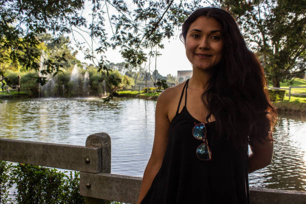 istock Beautiful young woman posing in a public park 2087408879