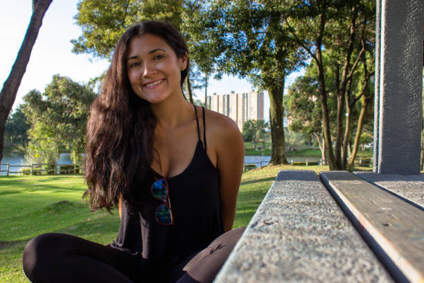 Beautiful young woman posing in a public park
