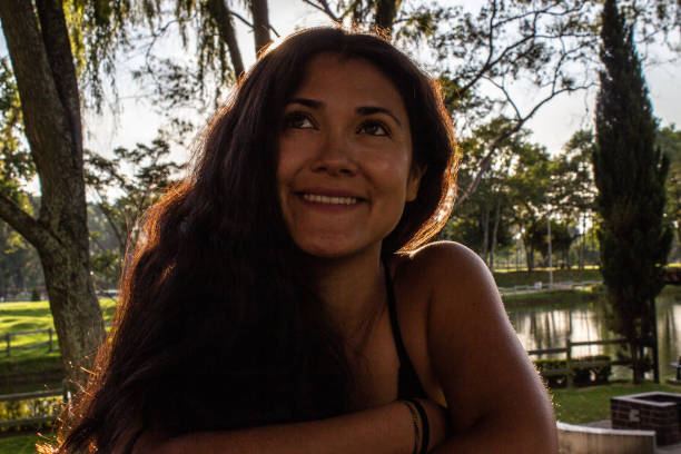 istock Beautiful young woman posing in a public park 2087410060
