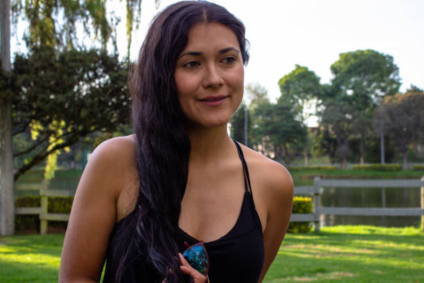 istock Beautiful young woman posing in a public park 2087412979
