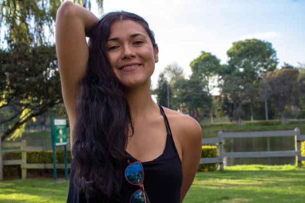 istock Beautiful young woman posing in a public park 2087412984
