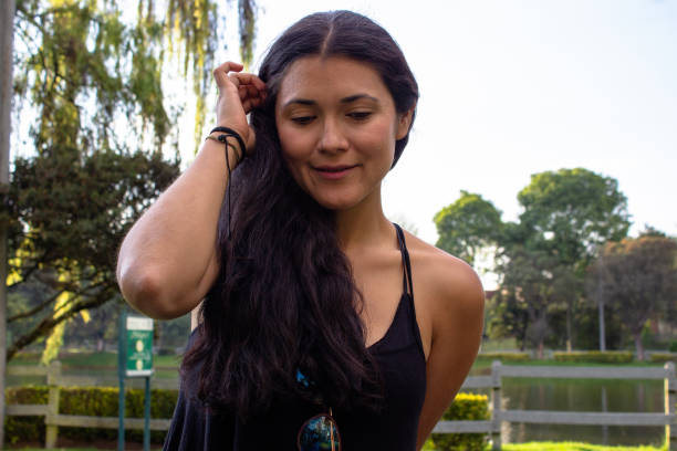 istock Beautiful young woman posing in a public park 2087413491