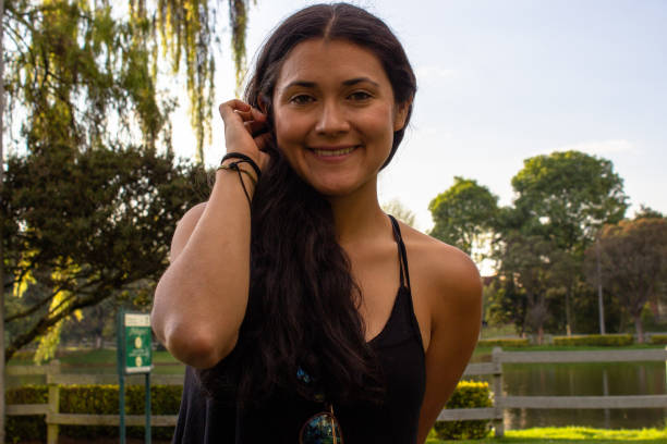 istock Beautiful young woman posing in a public park 2087413497