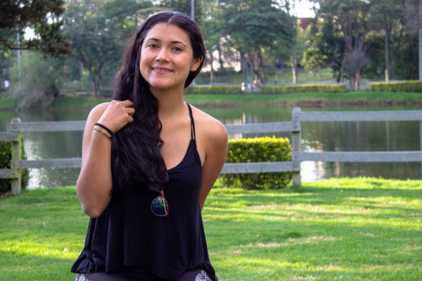 istock Beautiful young woman posing in a public park 2087413502