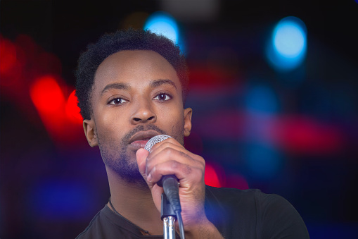 singer on a stage rock music concert musician performer holding microphone ready for karaoke