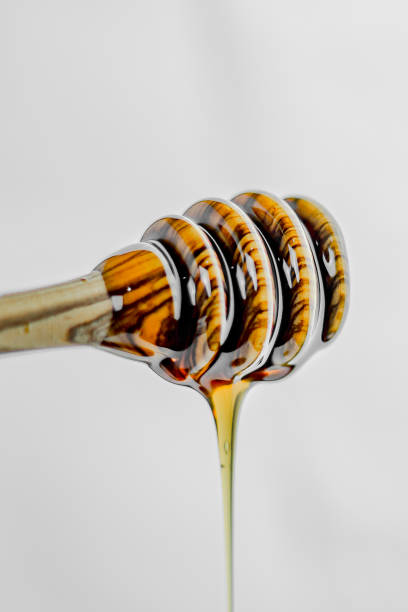 istock Olive wood honey spoon with honey close up view. 2087445064