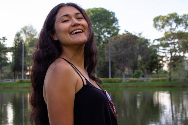 istock Beautiful young woman posing in a public park 2087453068