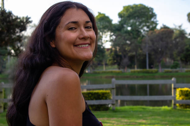 Beautiful young woman posing in a public park