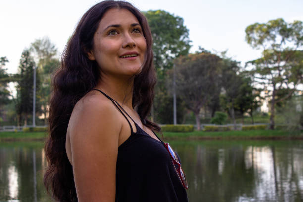 istock Beautiful young woman posing in a public park 2087453075