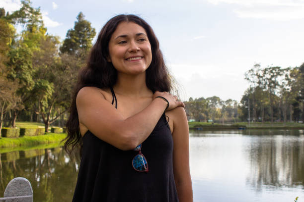istock Beautiful young woman posing in a public park 2087454628