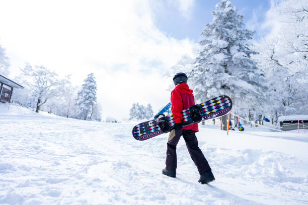 istock Asian woman practice snowboarding at ski area 2087493141