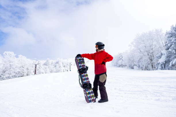 istock Asian woman practice snowboarding at ski area 2087493670