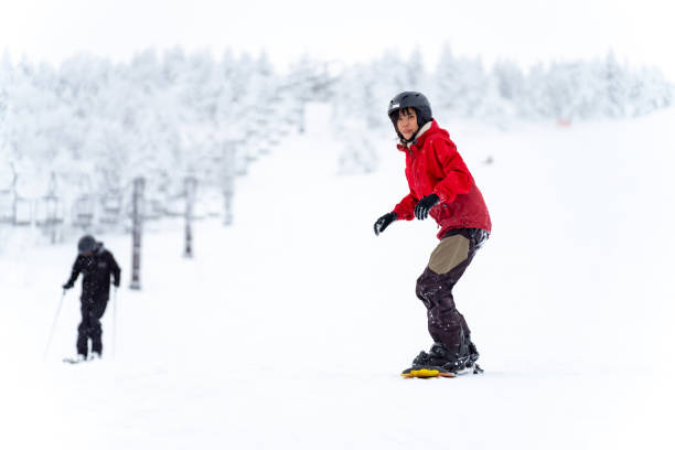 istock Asian woman practice snowboarding at ski area 2087493699