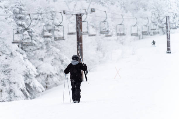 Young Asian man athlete practice downhill sliding skiing on snow mountain at ski resort. Handsome guy enjoy outdoor active lifestyle travel nature and winter extreme sport training on holiday vacation