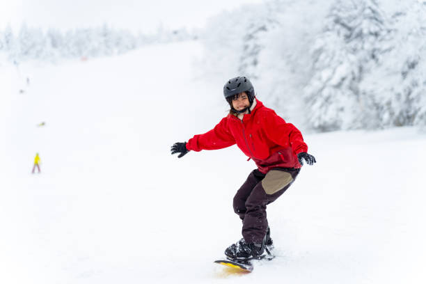 istock Asian woman practice snowboarding at ski area 2087493719