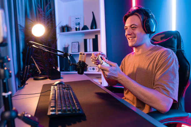 istock Streamer with control joystick live streaming by smartphone rec. Pecuniary. 2087512288