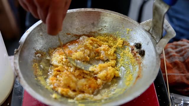 Duck eggs are broken into a frying pan filled with rice to make the typical Betawi egg crust