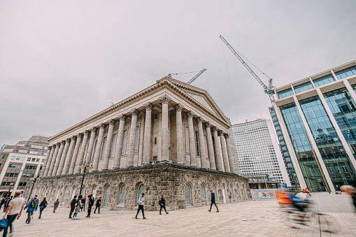 Low Angle View of Birmingham Town Hall in the City Centre with unrecognizable people walking & biking