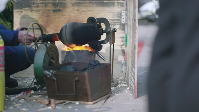 Asian old man making street snacks popcorns using traditional method