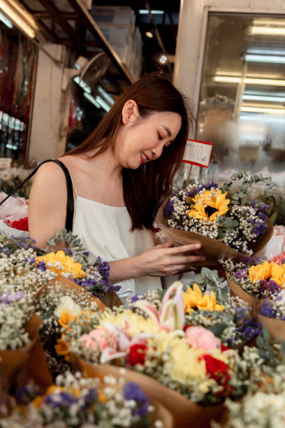 istock Woman selecting flowers 2087574419