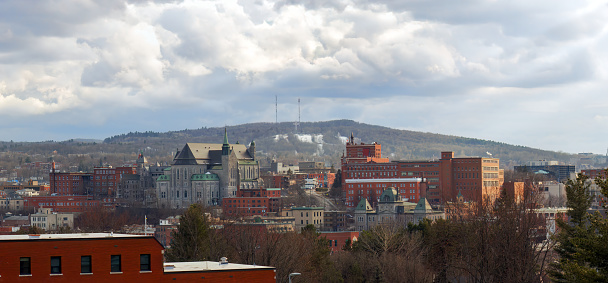 Small city Sherbrooke Estrie Quebec Eastern Townships Canada downtown mountain with clouds skyline