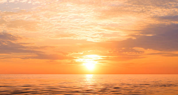 istock Sunset sky background over sea in the evening with beautiful yellow sunlight reflection on water surface in golden hour time 2087640482