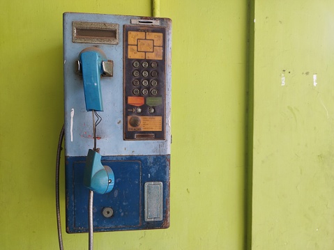 an outdated and unused public telephone