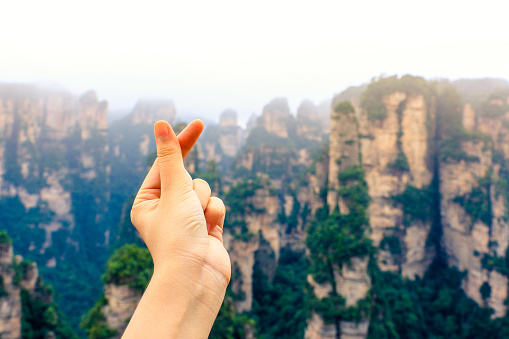 mini heart shape hand and lanscape of mountain pillars view in Zhangjiajie national forest park,Wulingyuan,Hunan,China