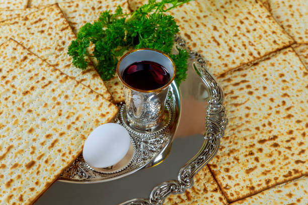 istock Kosher wine cup, matzah flatbread a celebrating passover with jewish pesach attributes 2087671112
