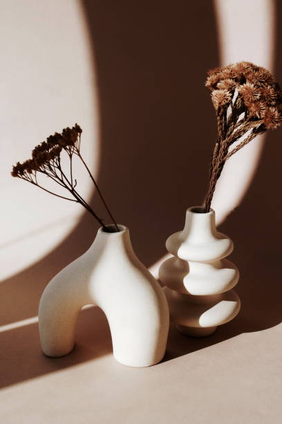 istock Modern beige ceramic vases set with dry grass on beige background and sunlight shadow.Copy space, Scandinavian interior accessories. Aesthetic poster 2087686578