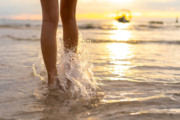 istock Woman's Leg walking on the beach at sunset 2087709256