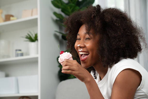 istock Funny African on mess face presenting cupcake in concept special. Tastemaker. 2087720332