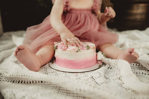 istock Little girl eating cake on her first birthday 2087729405