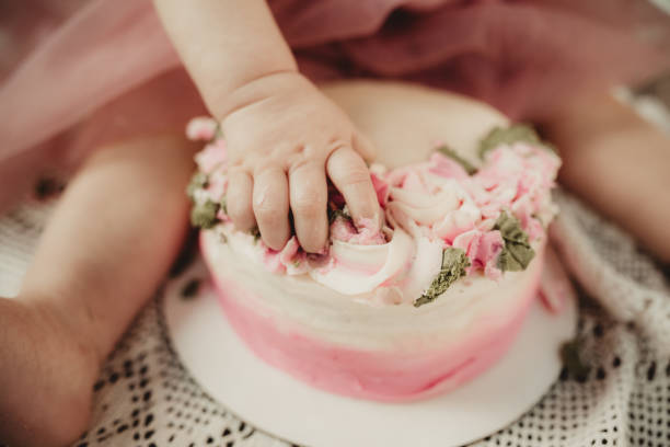 istock Little girl eating cake on her first birthday 2087729406