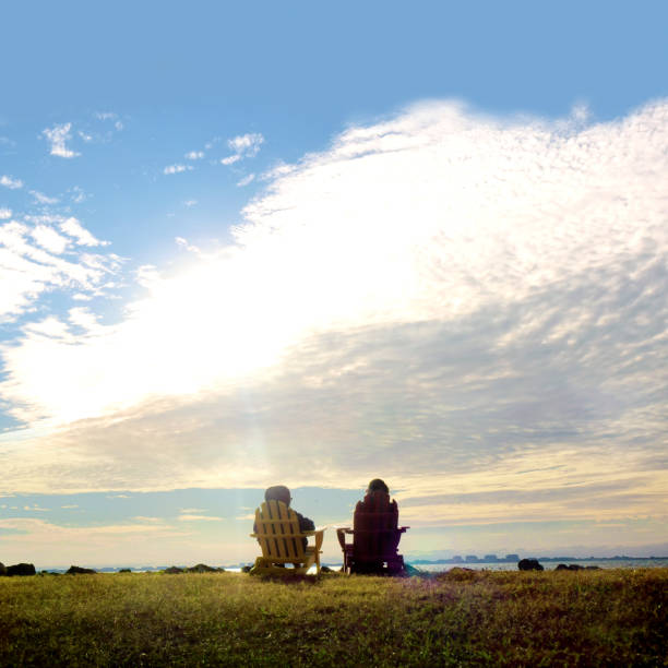 istock Two women sitting and watching sunset view in nature 2087737248