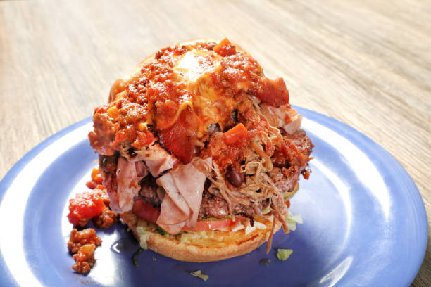 Loaded burger in plate on wooden table
