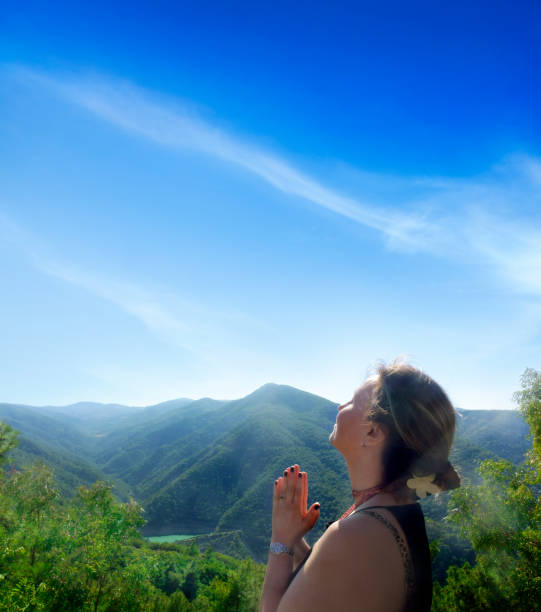 silhouette of a woman at sunset yoga cloudy sky