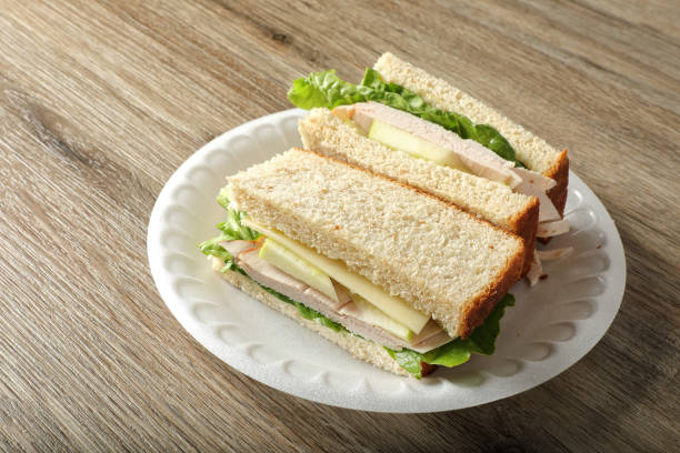 istock Chicken and cheese sandwich in plate on wooden table 2087761684