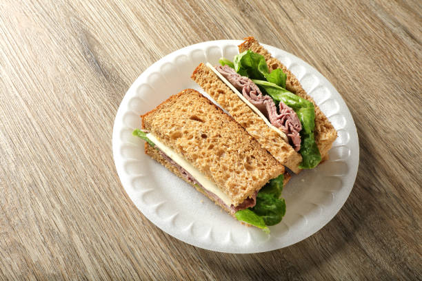 Tasty sandwich with salami sausage and vegetables isolated on white. With clipping path for design menu